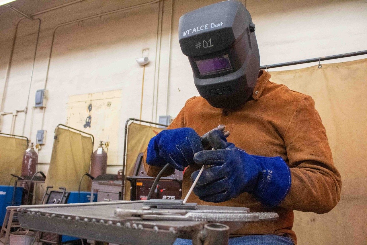 student arc welding in shop